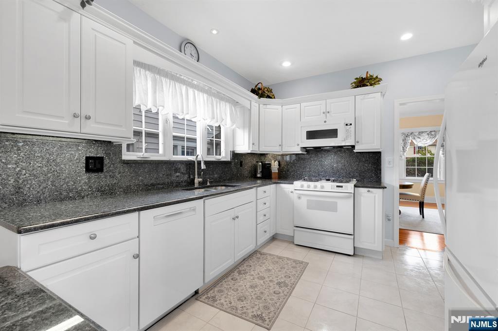 106 Maple Street Rutherford, NJ 07070 - Photo 21 of 50 a kitchen with cabinets appliances a sink and a window