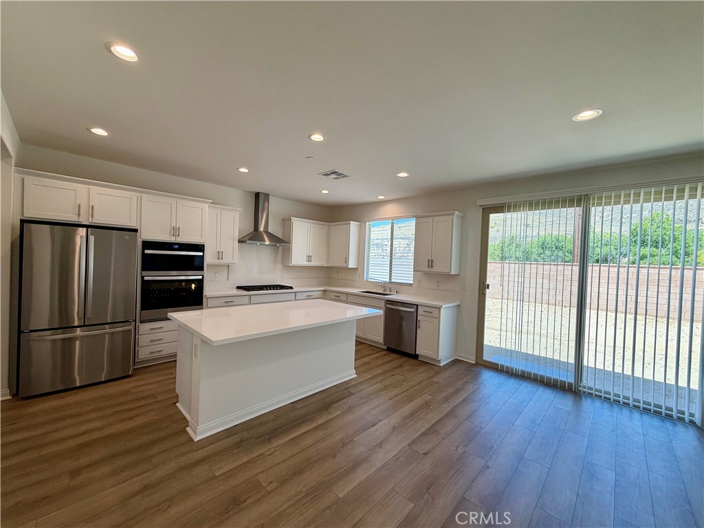 21624 Thomas Court Riverside, CA 92507 - Photo 9 of 36 a large kitchen with a large counter top a sink stainless steel appliances and cabinets