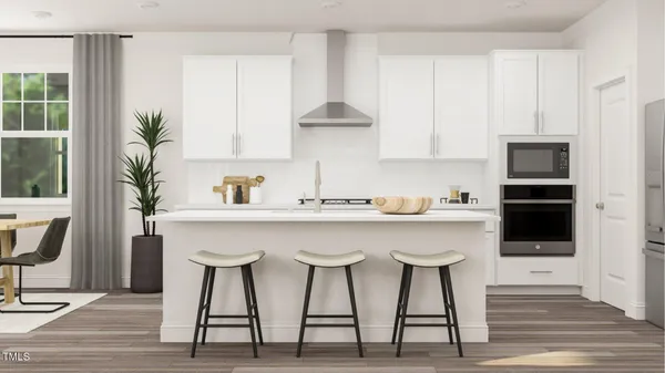 a kitchen with white cabinets and white appliances