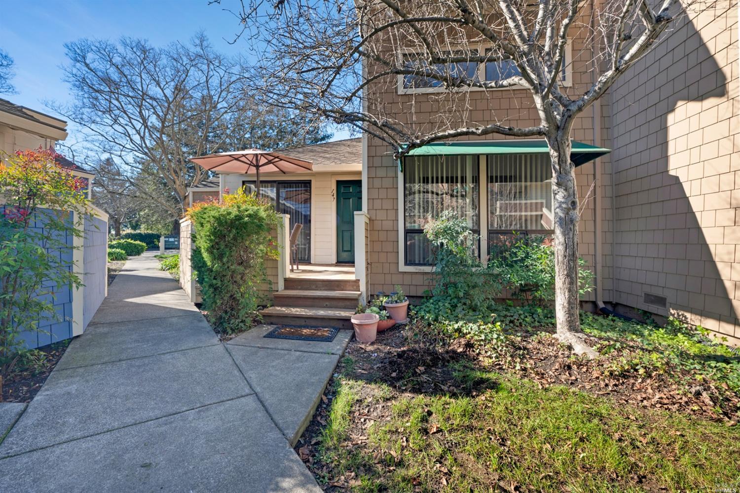 a front view of house with a garden