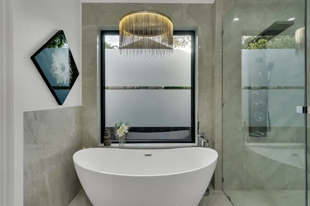 a bath tub sitting next to a bathroom sink