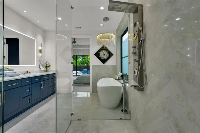 a spacious bathroom with a sink a mirror and a shower