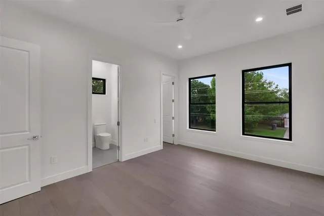 an empty room with windows and closet