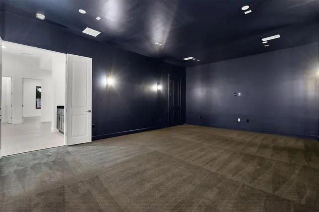 a backyard view of a house with garden and patio