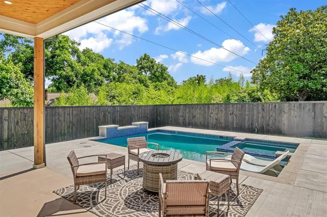 a view of a patio with table and chairs and potted plants