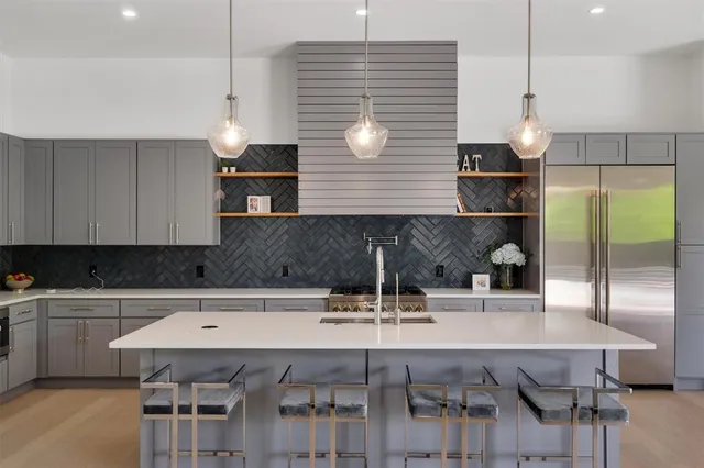 a kitchen with a table chairs sink and cabinets