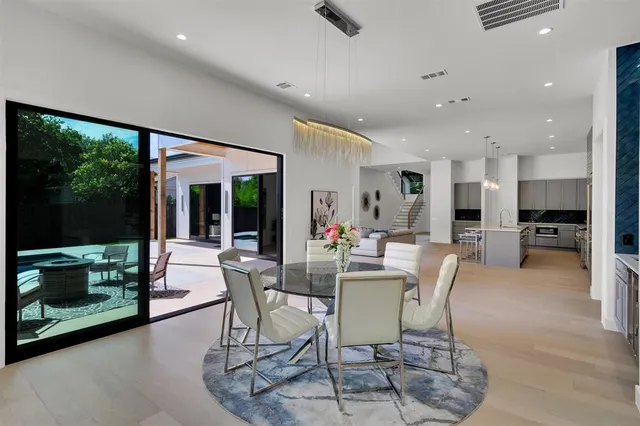 a dining room with furniture and a floor to ceiling window