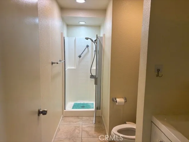 a bathroom with a shower and toilet