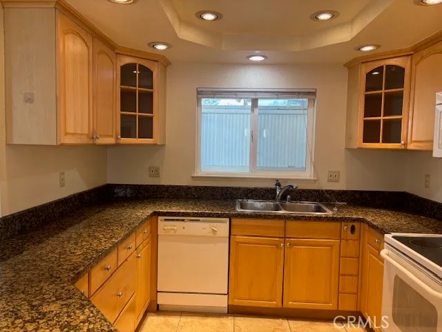 a kitchen with granite countertop a sink and cabinets