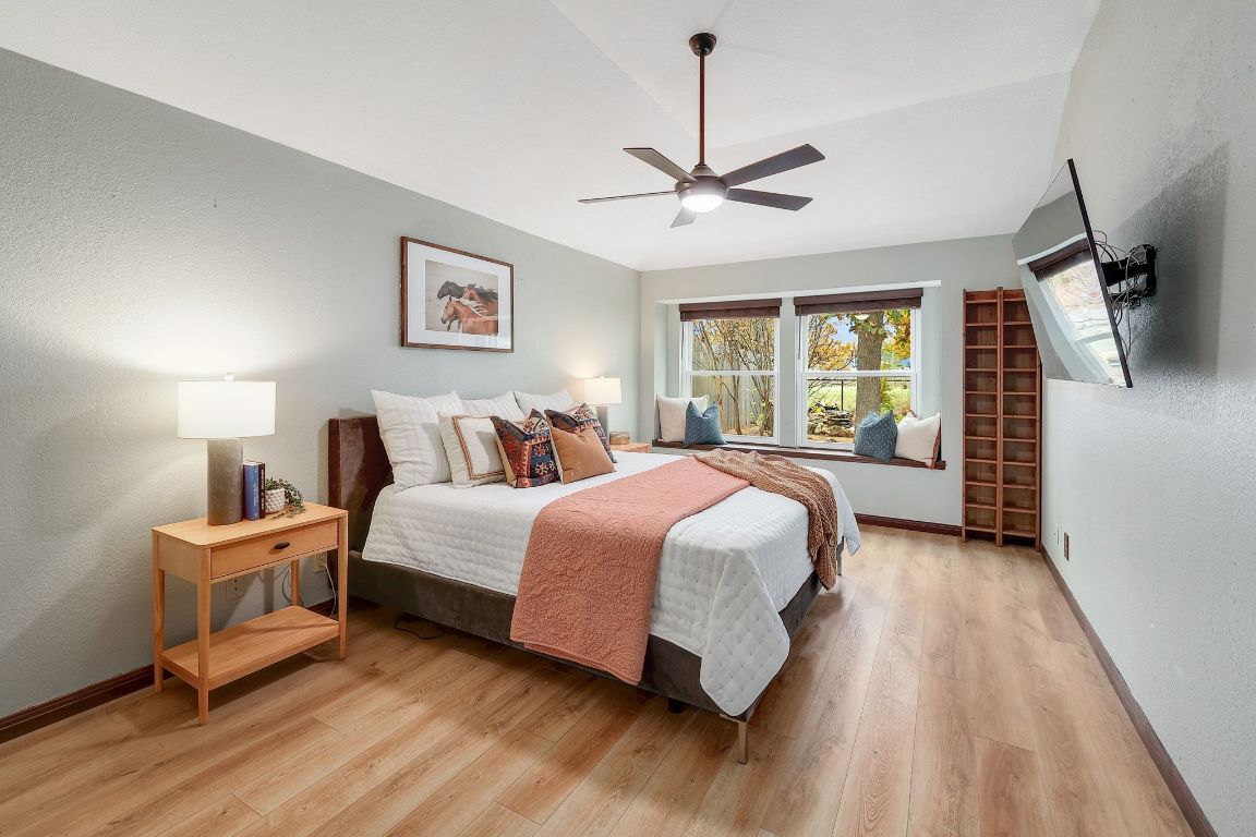 2307 Silverleaf Cove Round Rock, TX 78664 - Photo 13 of 31 a spacious bedroom with a bed chandelier and a window