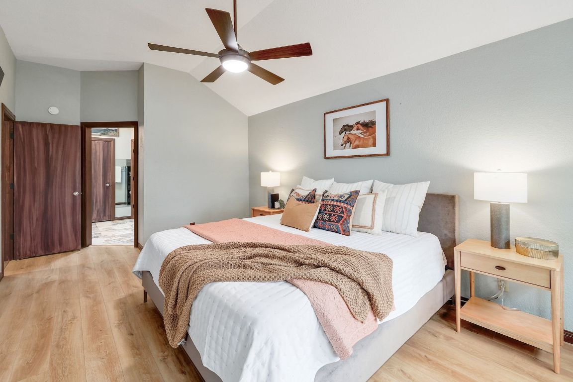 2307 Silverleaf Cove Round Rock, TX 78664 - Photo 14 of 31 a bedroom with bed and a chandelier