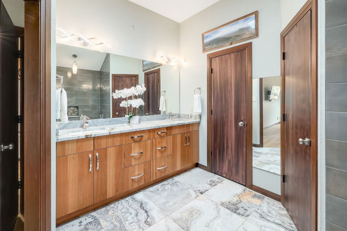 2307 Silverleaf Cove Round Rock, TX 78664 - Photo 15 of 31 a bathroom with a granite countertop sink mirror and shower