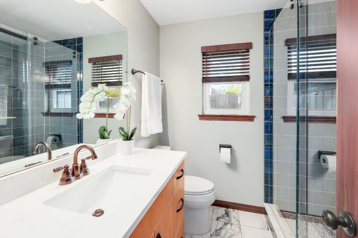 2307 Silverleaf Cove Round Rock, TX 78664 - Photo 19 of 31 a bathroom with a sink a toilet and shower
