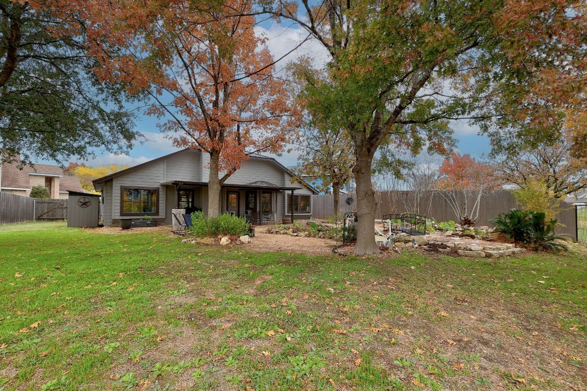 2307 Silverleaf Cove Round Rock, TX 78664 - Photo 26 of 31 a front view of a house with a garden and trees