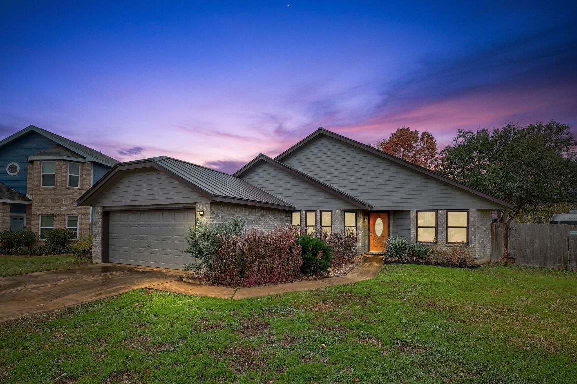 2307 Silverleaf Cove Round Rock, TX 78664 - Photo 4 of 31 a front view of a house with a garden and yard