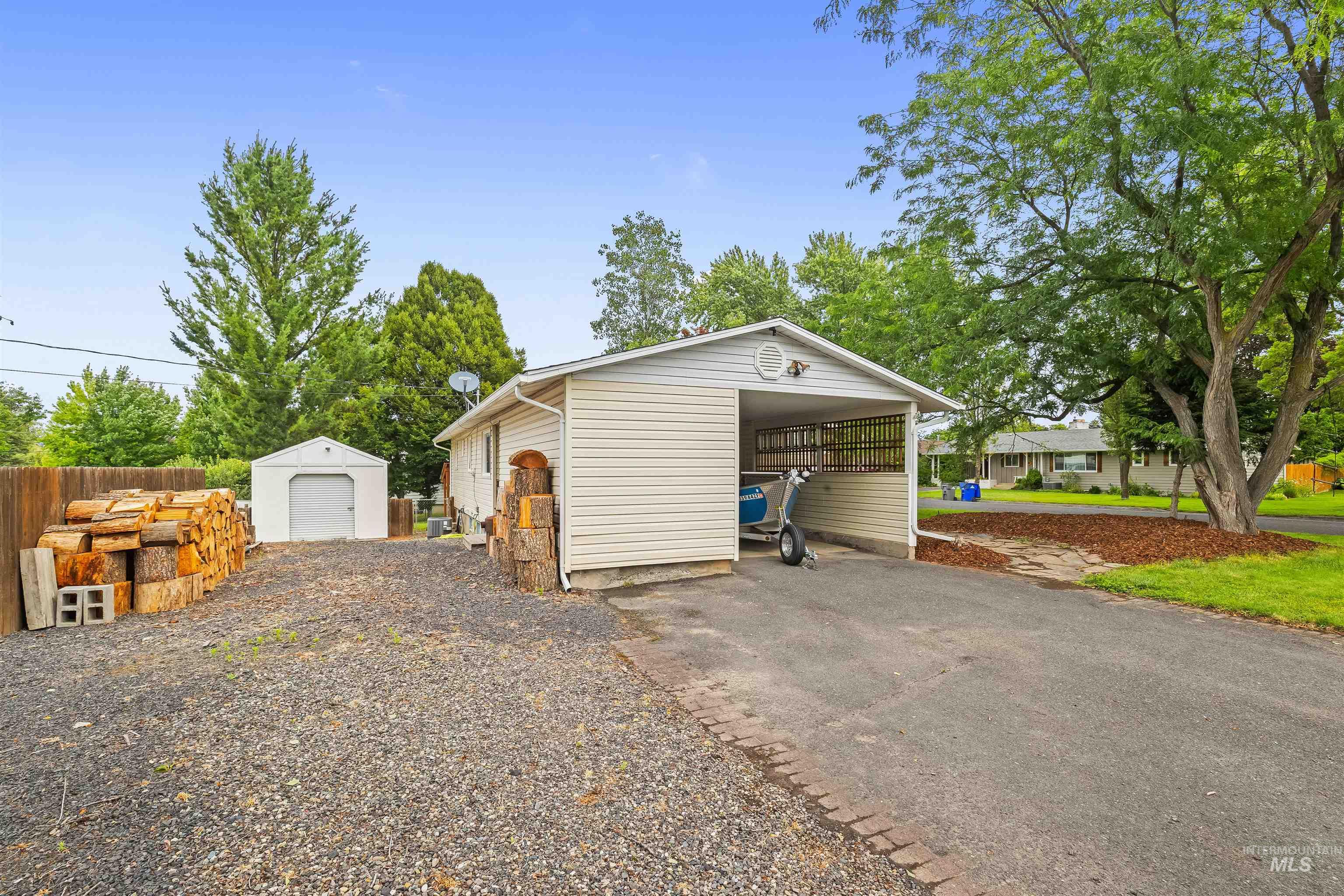 3620 18th Street Lewiston, ID 83501 - Photo 30 of 32 Exterior featuring a carport, detached shed, and gravel driveway