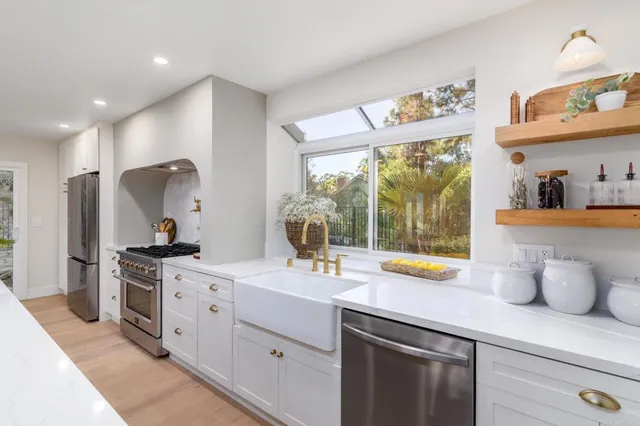 a kitchen with a sink stove and cabinets