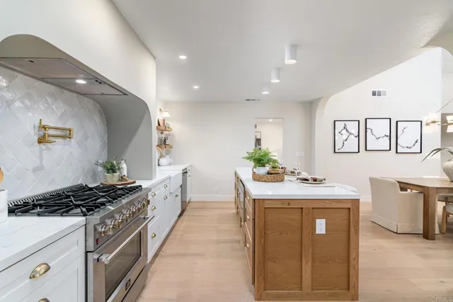a kitchen with a stove and a cabinets