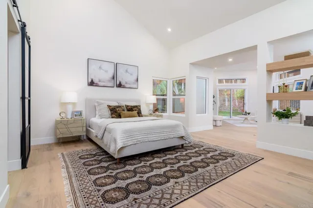 a bedroom with a large bed and a window