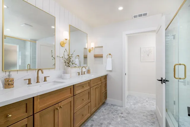 a bathroom with a double vanity sink mirror and double
