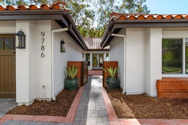 a view of a porch with furniture and floor to ceiling window