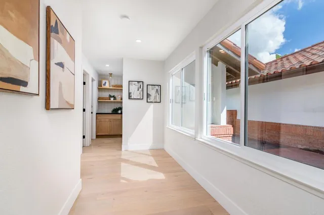 a bedroom with a bed and large windows