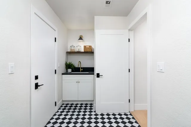 a view of a patio with couches and a table and chairs with wooden fence