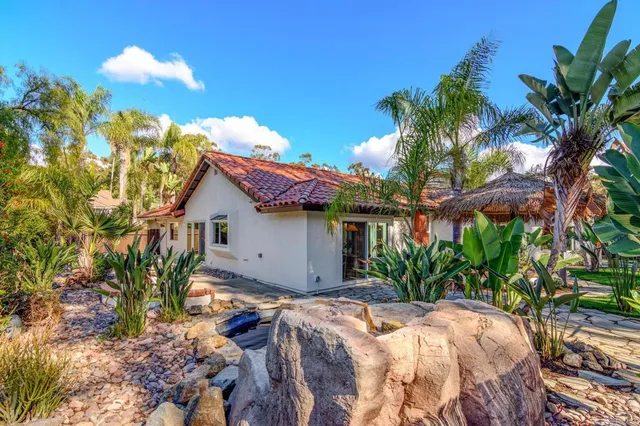 a view of a patio with table and chairs under an umbrella