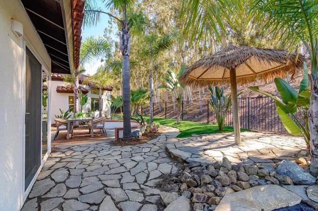 a view of a house with backyard porch and sitting area