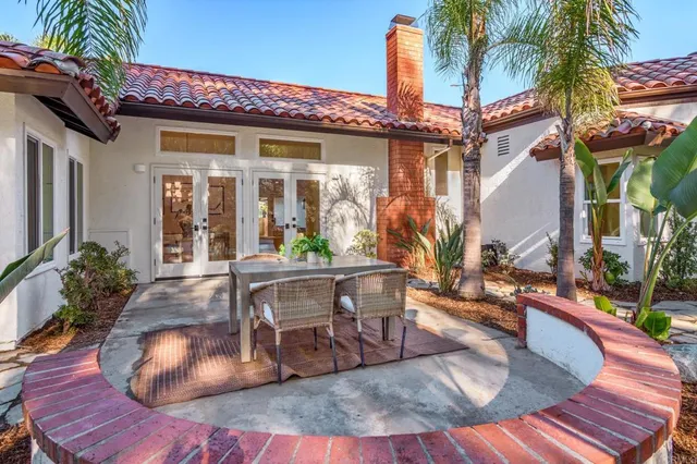a view of a house with backyard patio and swimming pool