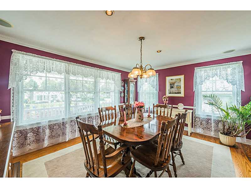 63 Colonel John Gardner Road Narragansett, RI 02882 - Photo 14 of 25 Dining Room. Large dining room has walls of windows and is just off of the kitchen.