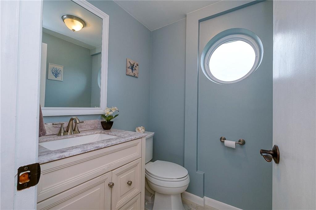 13730 Ridge Road North Huntingdon, PA 15642 - Photo 23 of 24 a bathroom with a toilet sink vanity and mirror