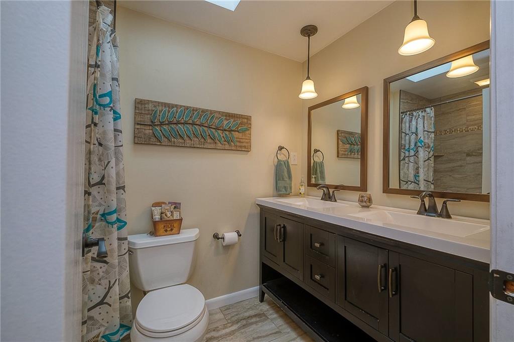 13730 Ridge Road North Huntingdon, PA 15642 - Photo 9 of 24 a bathroom with a double vanity sink toilet and mirror
