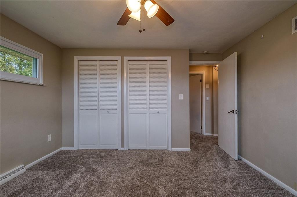 13730 Ridge Road North Huntingdon, PA 15642 - Photo 10 of 24 an empty room with a empty space and a ceiling fan