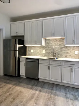 a kitchen with granite countertop cabinets stainless steel appliances and a sink