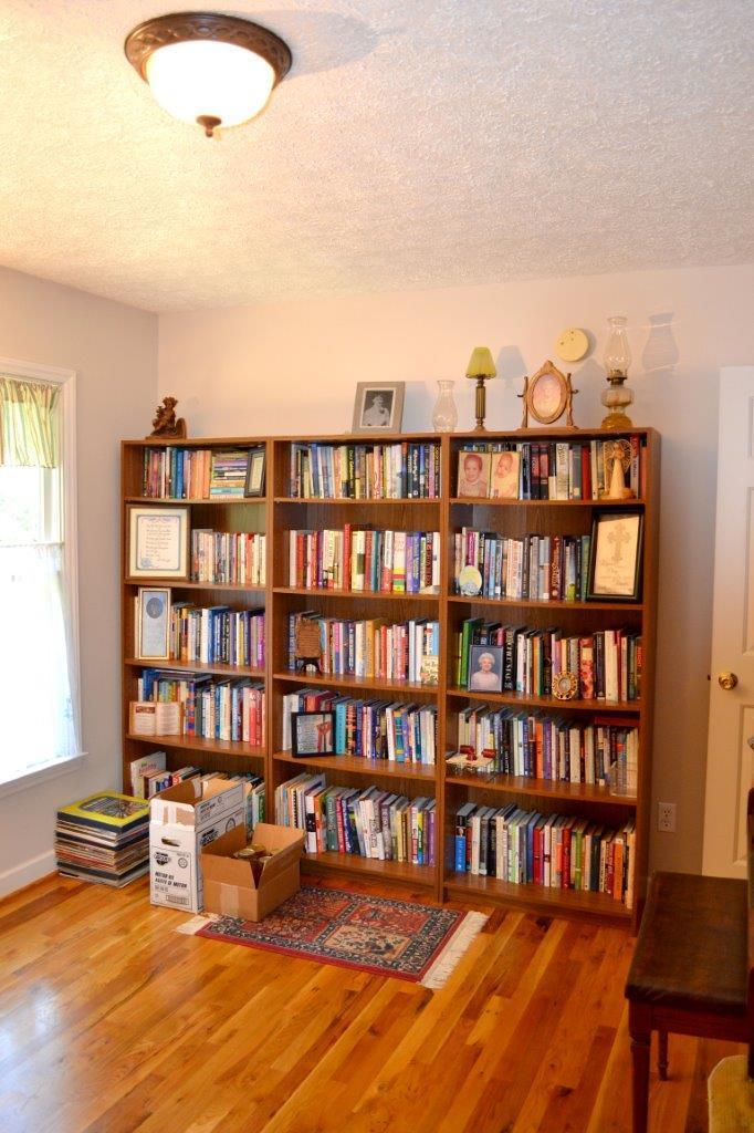 2588 Iron Ridge Road Rocky Mount, VA 24151 - Photo 13 of 65 a living room with furniture and a book shelf