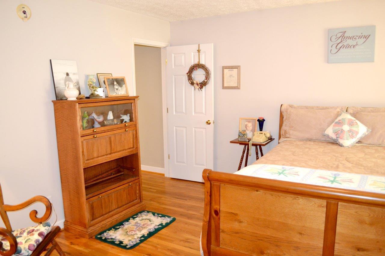 2588 Iron Ridge Road Rocky Mount, VA 24151 - Photo 17 of 65 a bedroom with furniture and wooden floor