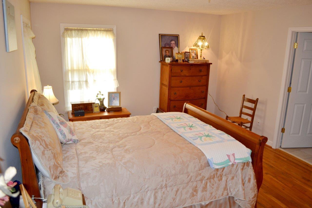 2588 Iron Ridge Road Rocky Mount, VA 24151 - Photo 19 of 65 a bedroom with a bed and wooden floor