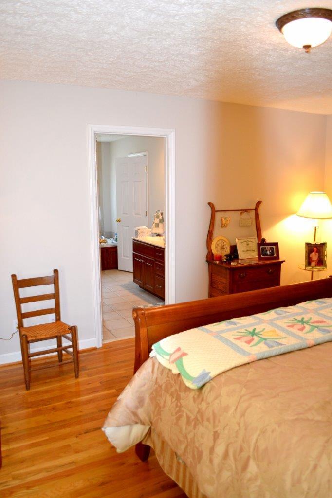 2588 Iron Ridge Road Rocky Mount, VA 24151 - Photo 20 of 65 a bedroom with a bed and wooden floor