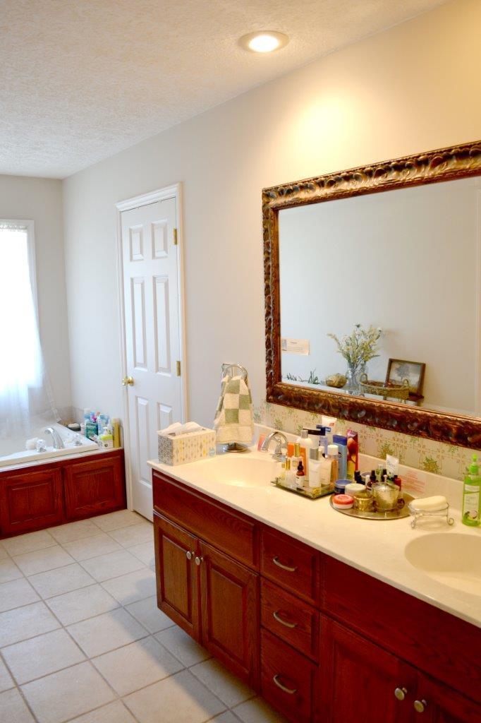 2588 Iron Ridge Road Rocky Mount, VA 24151 - Photo 21 of 65 a spacious bathroom with a double vanity sink and a mirror