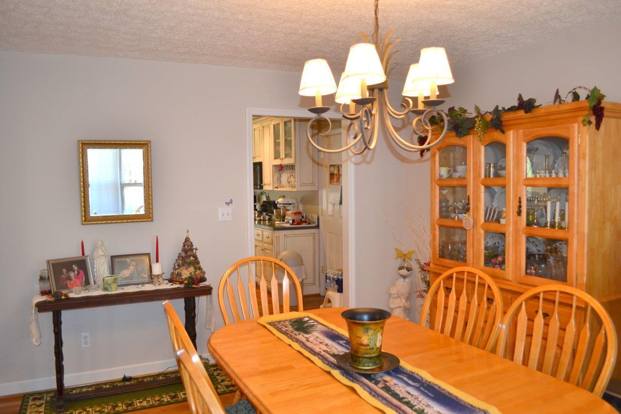 2588 Iron Ridge Road Rocky Mount, VA 24151 - Photo 33 of 65 a view of a dining room with furniture a chandelier and wooden floor