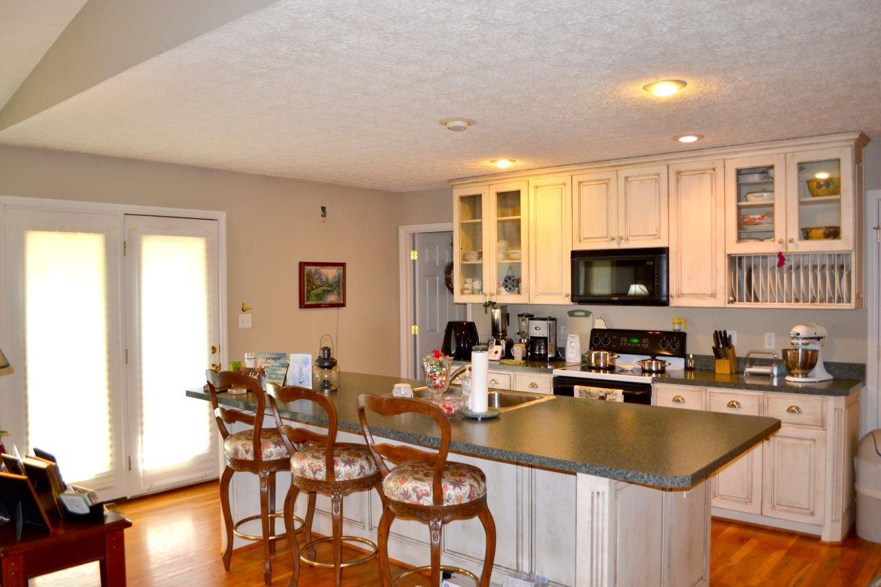 2588 Iron Ridge Road Rocky Mount, VA 24151 - Photo 40 of 65 a kitchen with center island table and chairs