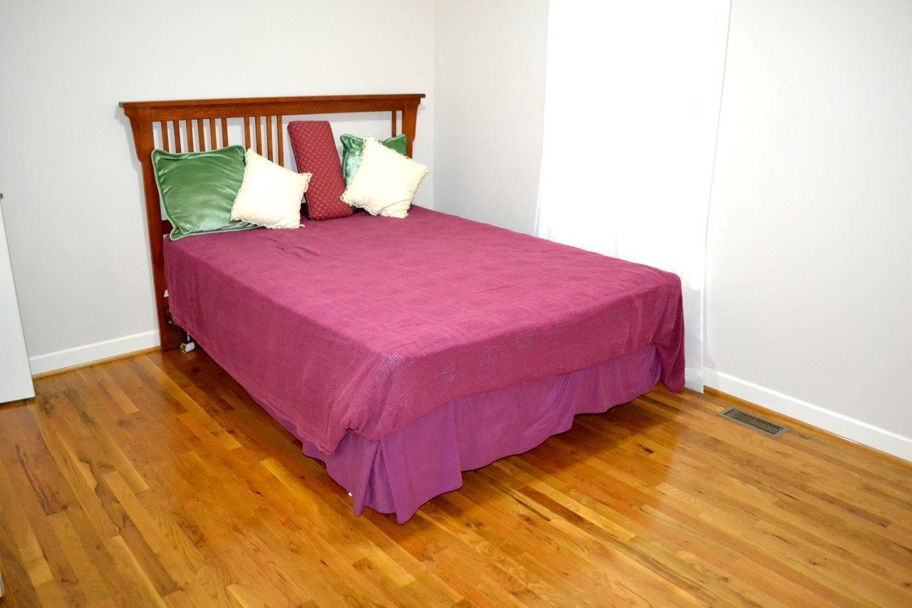 2588 Iron Ridge Road Rocky Mount, VA 24151 - Photo 10 of 65 a bed sitting in a bedroom next to a window