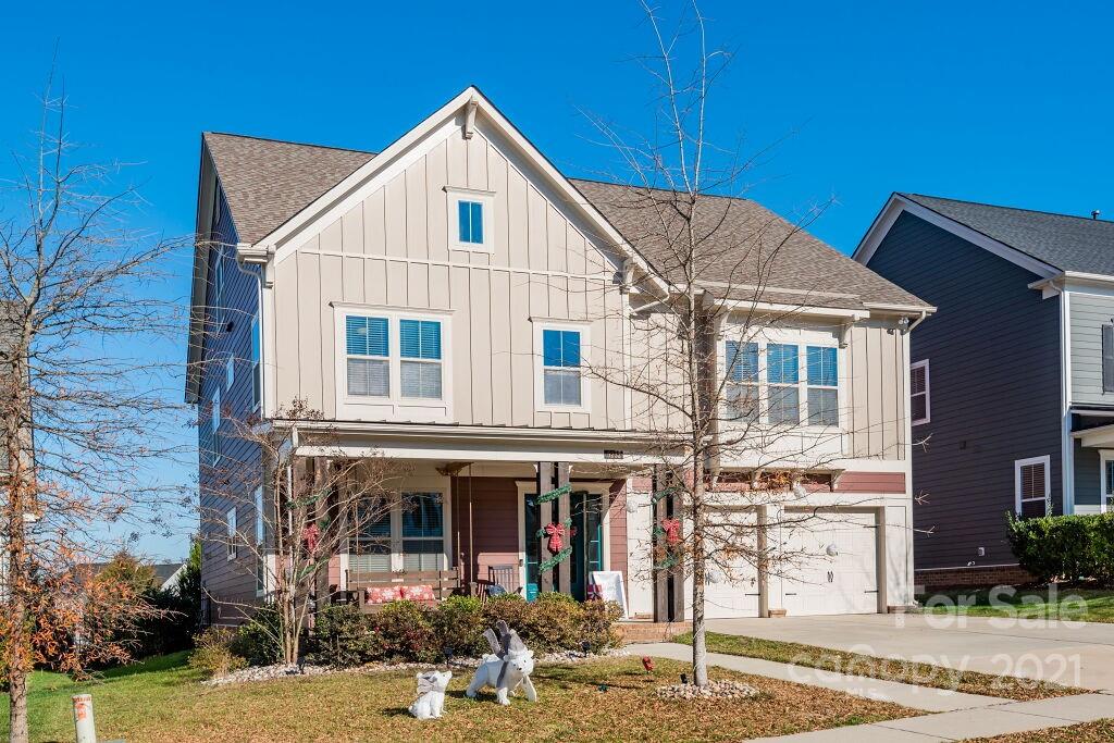 5232 Meadowcroft Way Fort Mill, SC 29708 - Photo 3 of 44 a view of a white house with large windows and a small yard