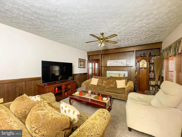 a bedroom with furniture and a flat screen tv