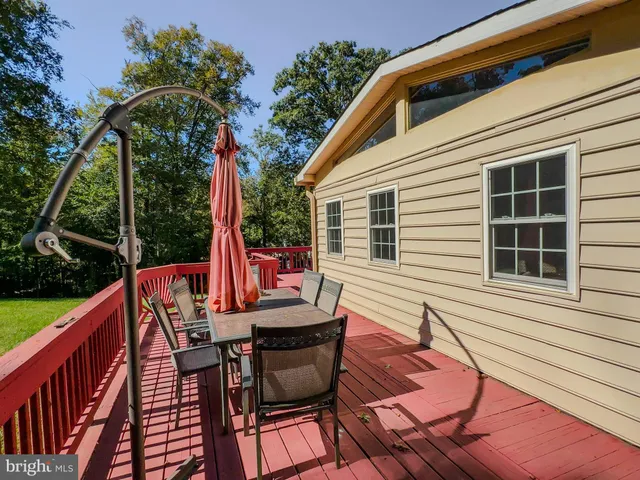 a view of deck with table and chairs and wooden floor