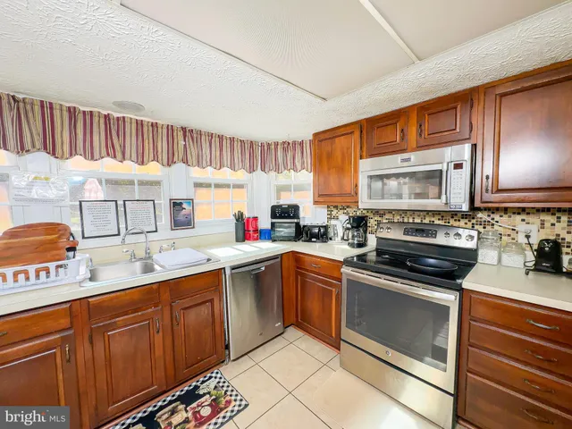 a kitchen with a sink stove and microwave