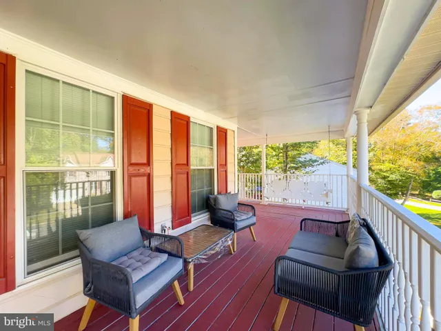 a living room with furniture and floor to ceiling windows