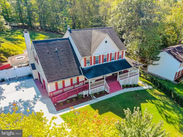 an aerial view of a house with swimming pool and deck