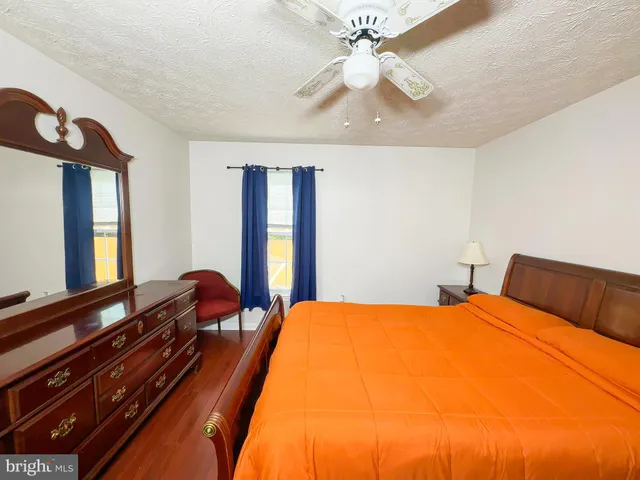 a bed room with a bed mirror and a window